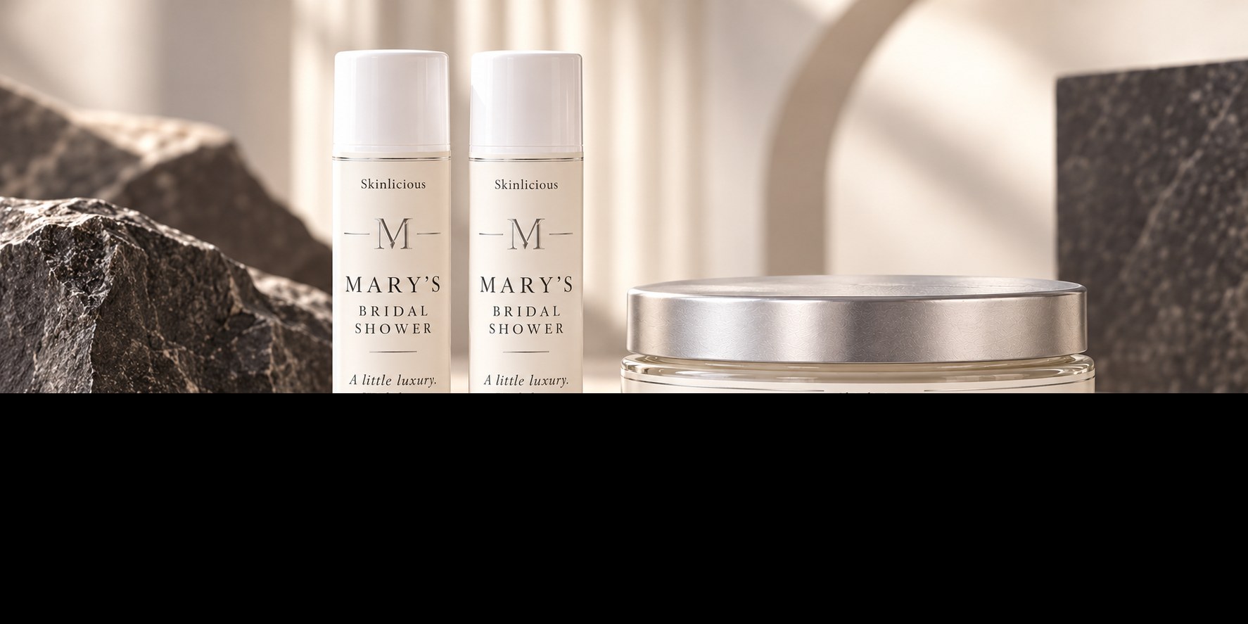 Minimal cream and charcoal monogram labels on lip balms and the shallow silver-lidded body butter jar